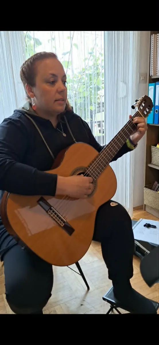 Učenka igra klasično kitaro.